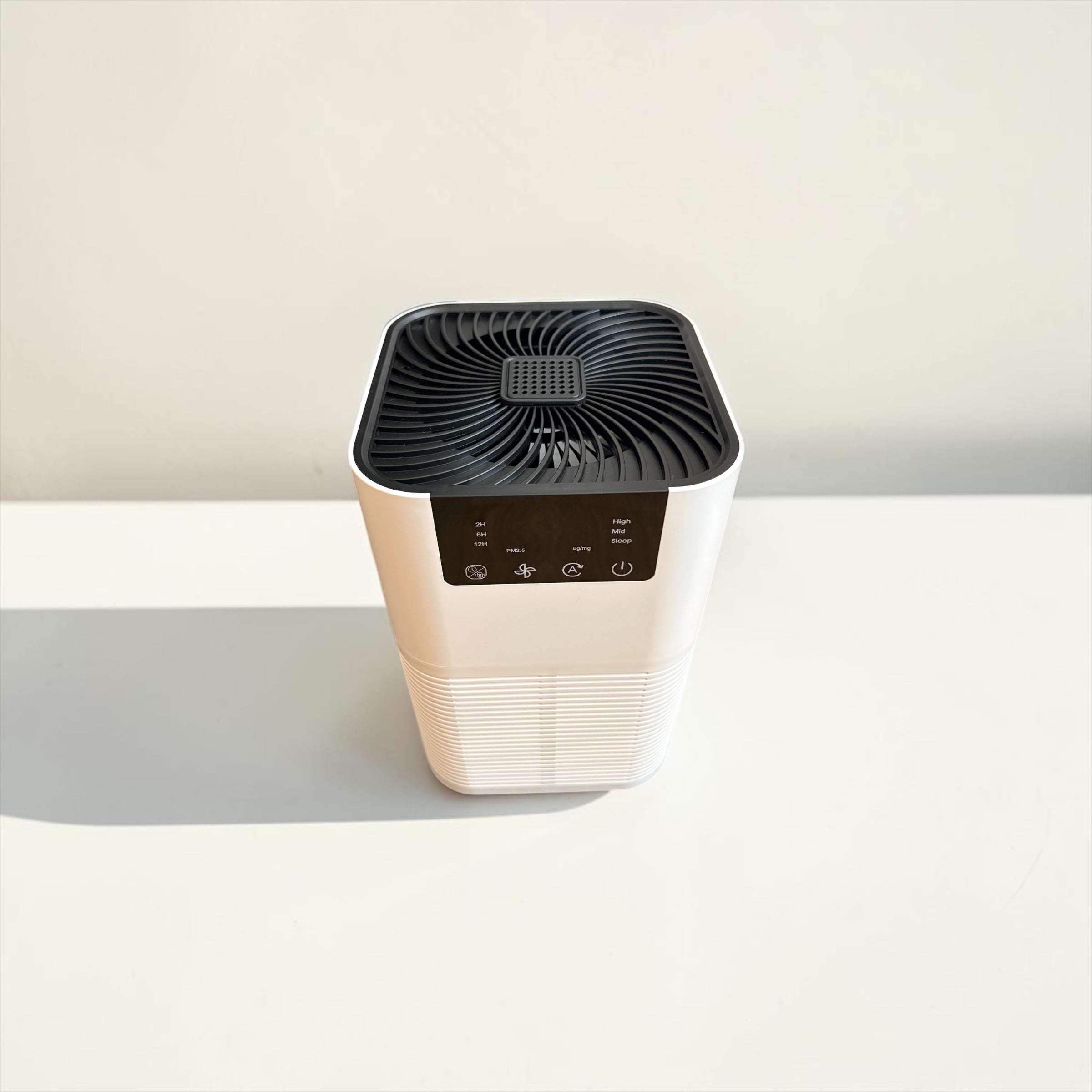 Air purifier on a light gray surface with a white background