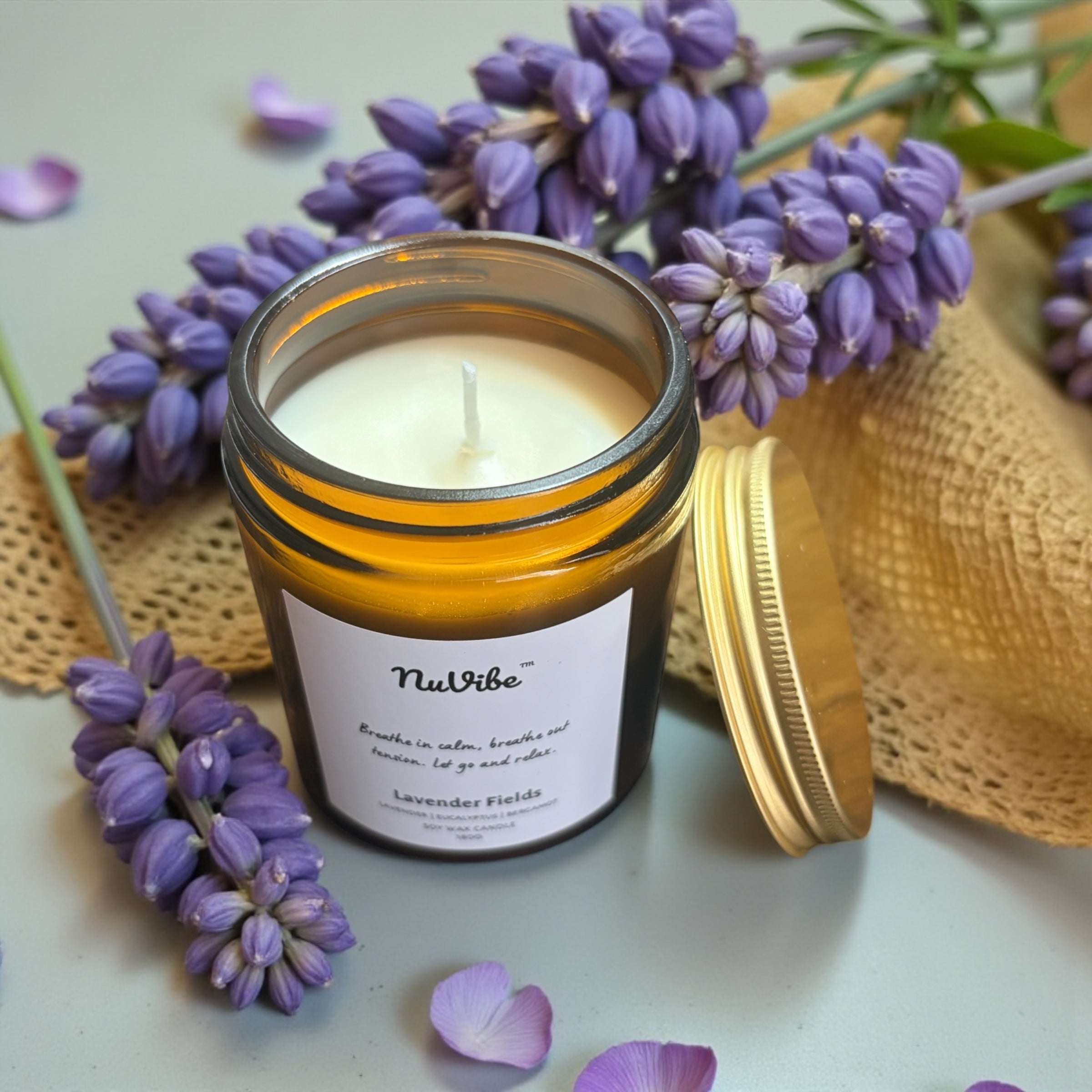 NuVibe lavender fields soy wax candle in amber jar styled with purple lavender, elegant home décor candle perfect for gifts and cosy evenings