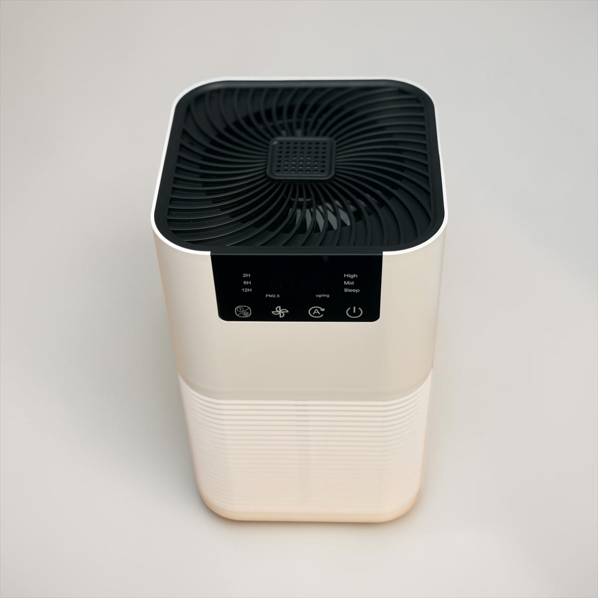Air purifier with black top and beige base on a light gray background