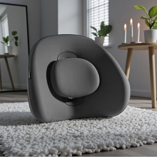 NuVibe™ x CICIDO ErgoLuxe Cushion in Pure Black in a modern wellness room, premium ergonomic back cushion designed for posture support and everyday sitting comfort.