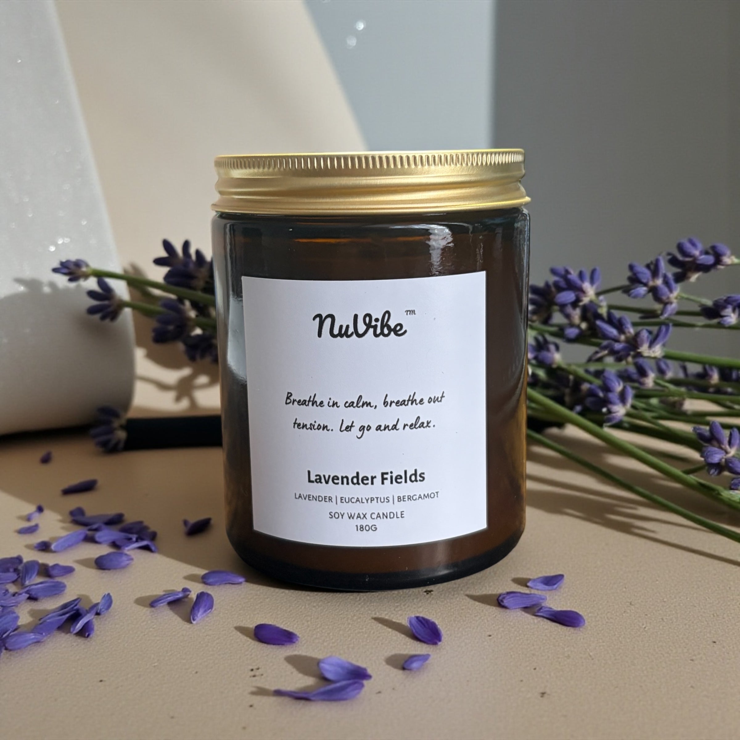 NuVibe lavender fields soy wax candle in amber jar styled with purple lavender, elegant home décor candle perfect for gifts and cosy evenings