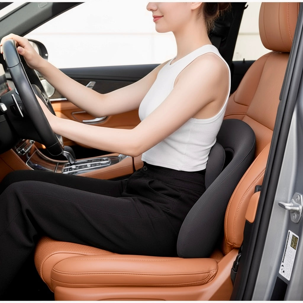 NuVibe™ x CICIDO ErgoLuxe Cushion in Pure Black, used as a lumbar support cushion in car seat for improved posture and comfort while driving.