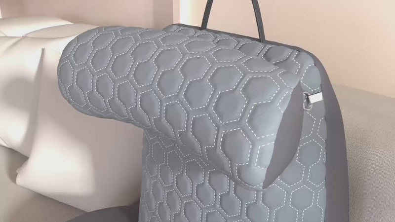 A 3D animation of the NuVibe Cushion, showcasing the different features it has such as the adjustable headrest, arm rest and side pockets.
